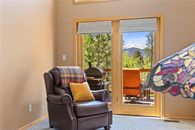 living area featuring a mountain view, carpet floors, visible vents, and baseboards