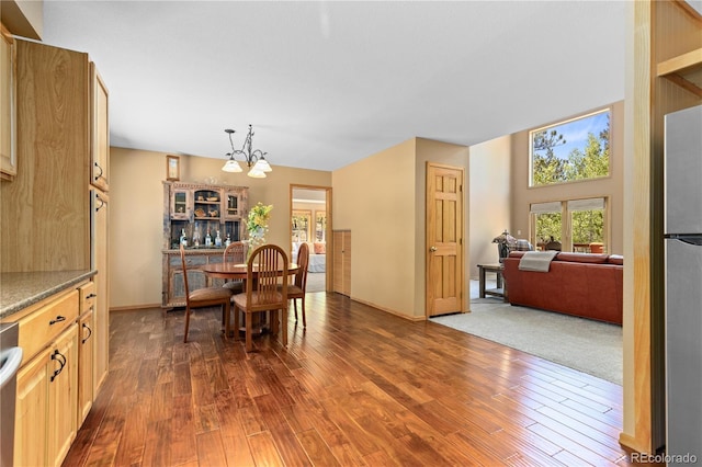 dining space featuring a chandelier and dark wood finished floors