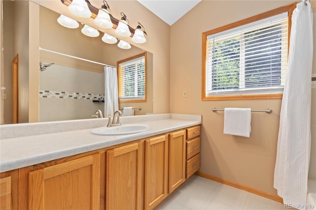 full bath featuring a shower with curtain, vanity, and baseboards