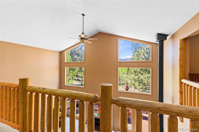 interior space featuring a healthy amount of sunlight, vaulted ceiling, and an upstairs landing