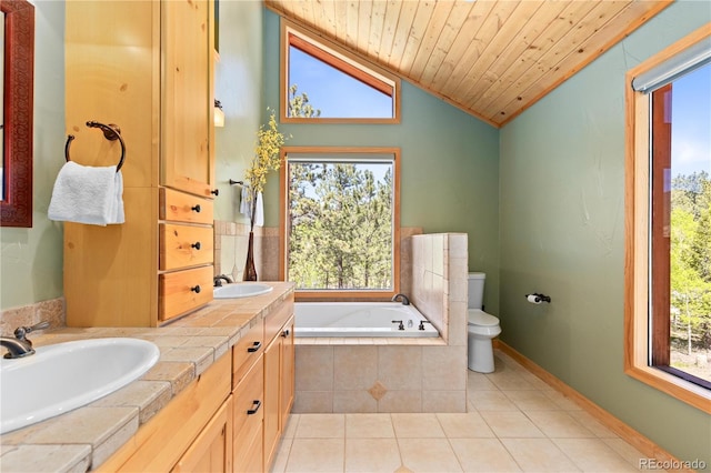 full bathroom featuring toilet, tile patterned floors, a sink, vaulted ceiling, and a bath