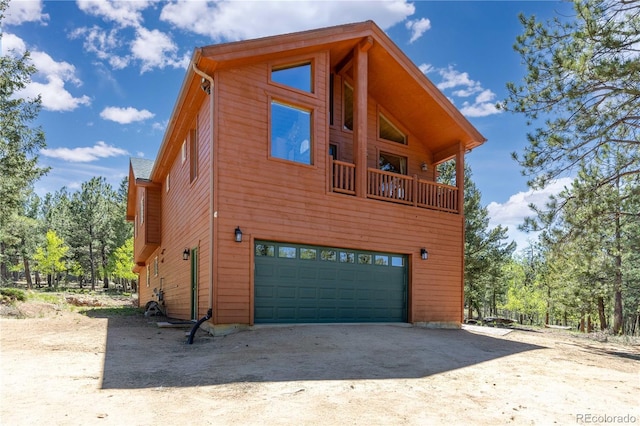 view of side of home with a garage and driveway