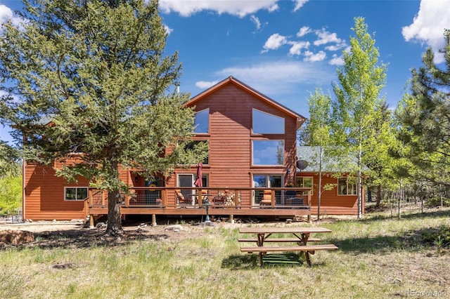 rear view of property featuring a deck