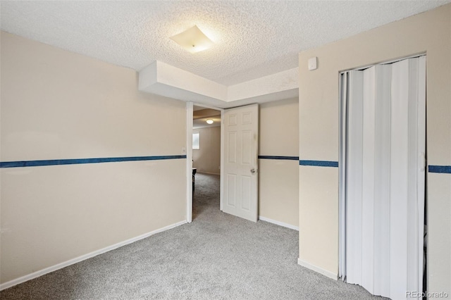 6545 Brook Forest Dr, Colorado Springs, CO 80911 - unfurnished bedroom featuring carpet floors, a textured ceiling, and a closet