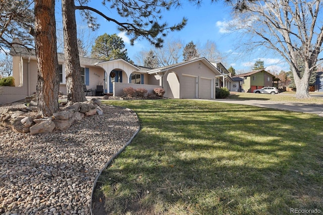 ranch-style house featuring a front yard and a garage