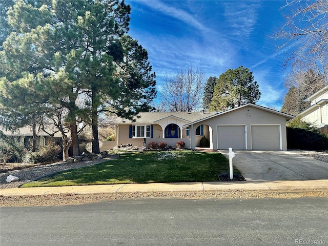 ranch-style home with a front yard and a garage