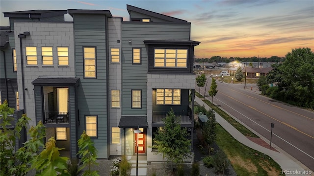 6799 Navajo St, Denver, CO 80221 - back of house at dusk featuring a balcony