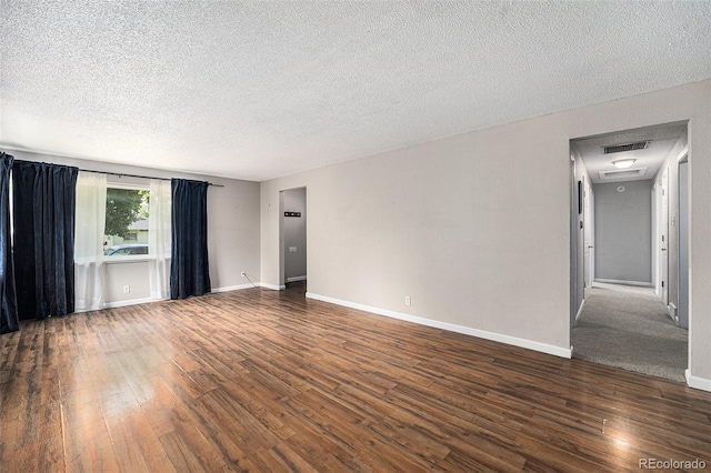2308 Lima St, Aurora, CO 80010 - spare room featuring dark wood-style flooring and a textured ceiling
