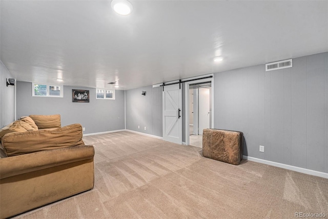 2308 Lima St, Aurora, CO 80010 - living area featuring a barn door and carpet floors