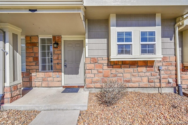 property entrance featuring stone siding