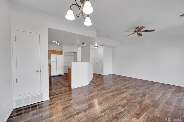 unfurnished living room featuring visible vents, dark wood-style flooring, and ceiling fan with notable chandelier