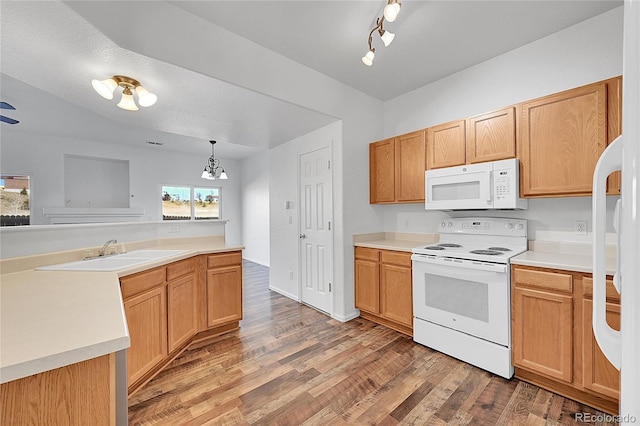 kitchen with white appliances, light countertops, light wood-type flooring, and a sink