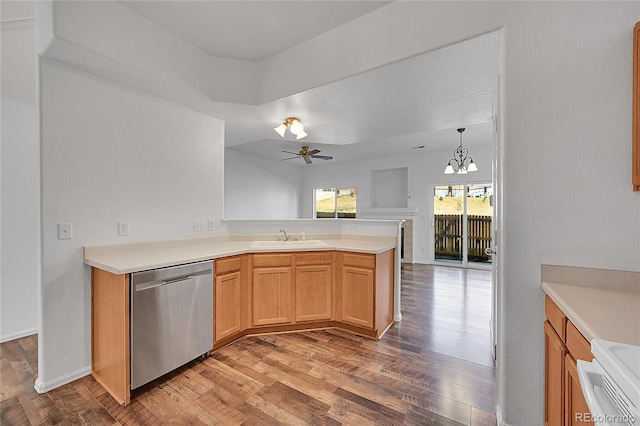 kitchen with a sink, light wood-style flooring, a peninsula, and stainless steel dishwasher