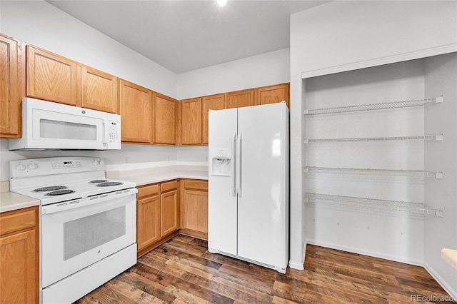 kitchen with dark wood finished floors, white appliances, and light countertops