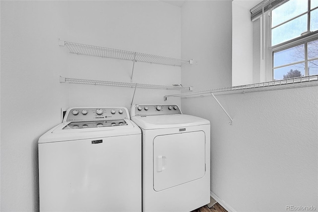 clothes washing area with independent washer and dryer and laundry area