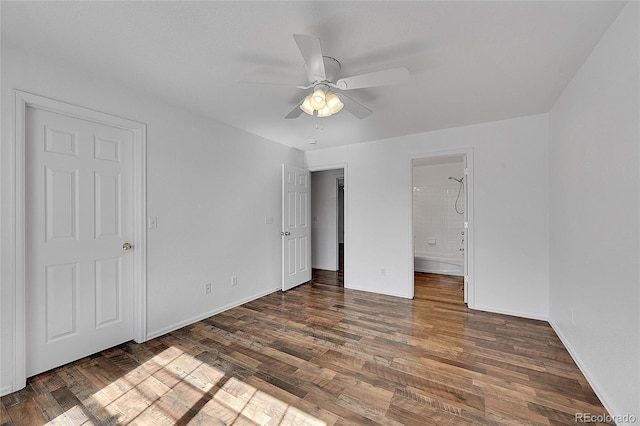 unfurnished bedroom featuring ensuite bathroom, ceiling fan, and wood finished floors