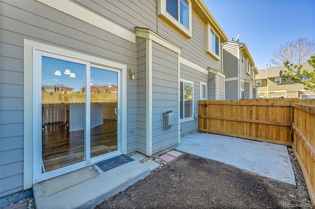 doorway to property featuring fence