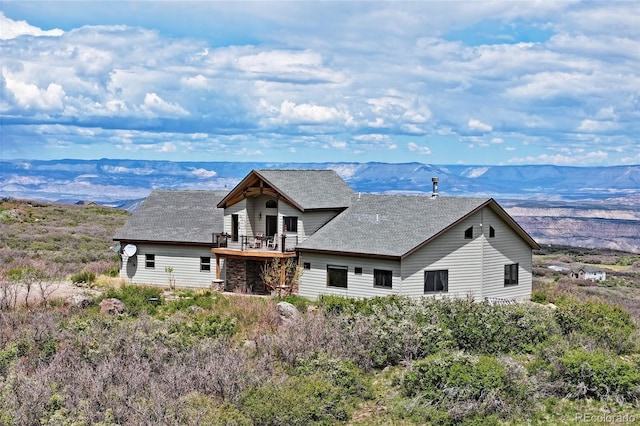 53315 Bull Basin Rd, Mesa, CO 81643 - rear view of property with a mountain view, a shingled roof, and a balcony
