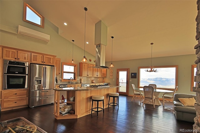 53315 Bull Basin Rd, Mesa, CO 81643 - kitchen featuring appliances with stainless steel finishes, high vaulted ceiling, an AC wall unit, a center island, and island range hood