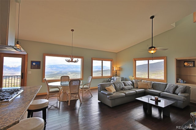 53315 Bull Basin Rd, Mesa, CO 81643 - living room with dark wood finished floors, baseboards, a ceiling fan, a chandelier, and high vaulted ceiling
