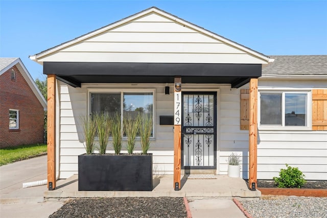 1749 Havana St, Aurora, CO 80010 - property entrance with covered porch and roof with shingles