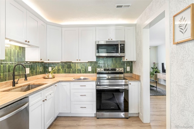 1749 Havana St, Aurora, CO 80010 - kitchen with appliances with stainless steel finishes, a sink, and light countertops