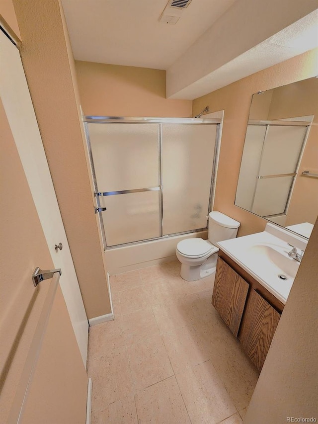 full bath with toilet, vanity, and shower / bath combination with glass door