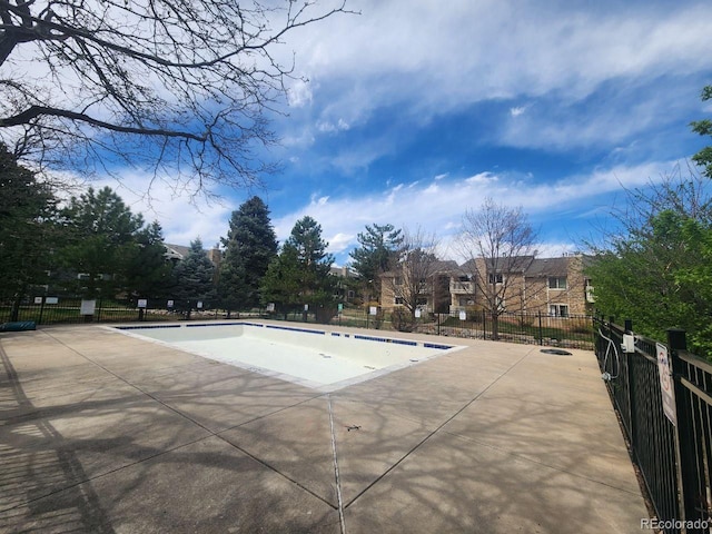 pool featuring a patio and fence