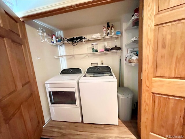 laundry room with light hardwood / wood-style floors and independent washer and dryer