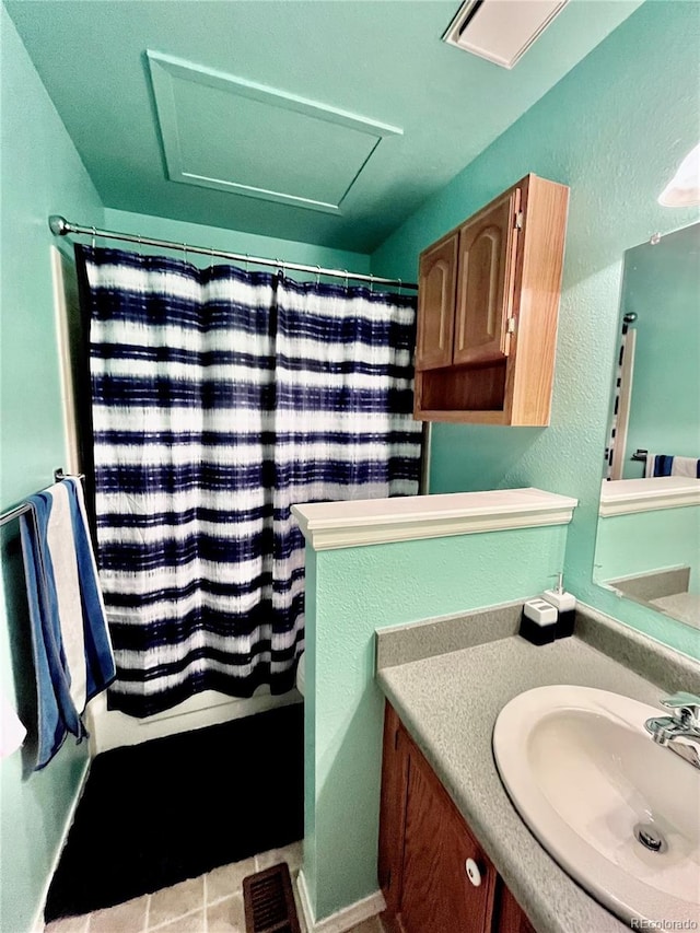 bathroom with tile patterned flooring and vanity