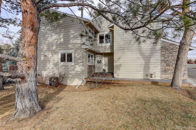 rear view of property with a yard