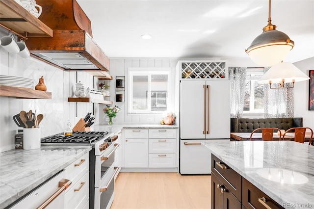 kitchen with custom exhaust hood, open shelves, light wood-style floors, white cabinetry, and high quality appliances