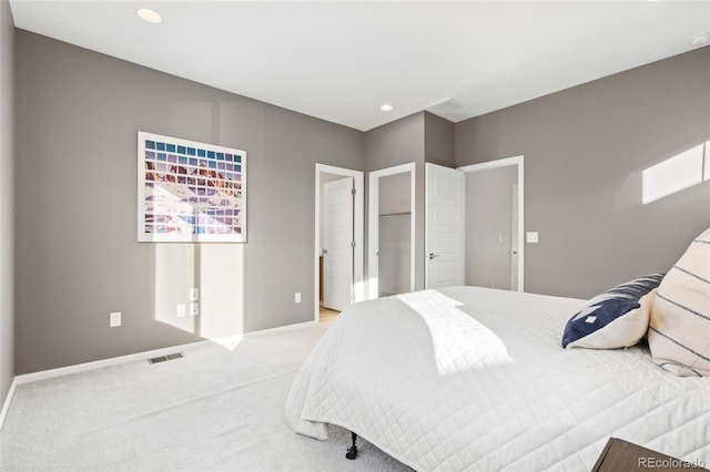 bedroom with recessed lighting, visible vents, baseboards, and light colored carpet