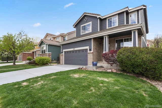 16164 E Hinsdale Ave, Aurora, CO 80016 - craftsman-style home with concrete driveway, brick siding, an attached garage, and a front yard