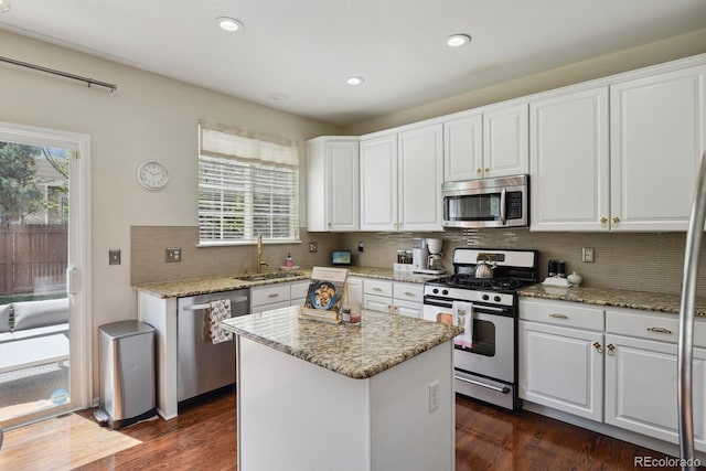 16164 E Hinsdale Ave, Aurora, CO 80016 - kitchen featuring a sink, stainless steel appliances, white cabinetry, and a healthy amount of sunlight