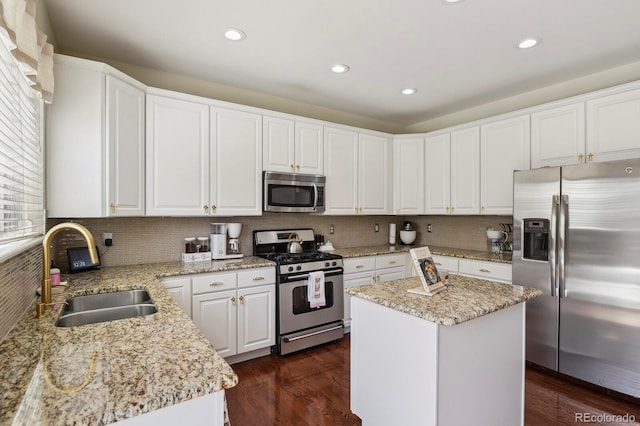 16164 E Hinsdale Ave, Aurora, CO 80016 - kitchen with a sink, decorative backsplash, appliances with stainless steel finishes, and white cabinetry