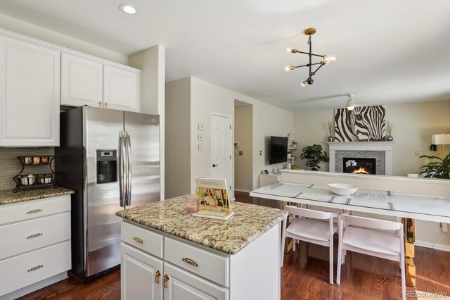 16164 E Hinsdale Ave, Aurora, CO 80016 - kitchen featuring a kitchen island, a notable chandelier, dark wood finished floors, open floor plan, and stainless steel fridge