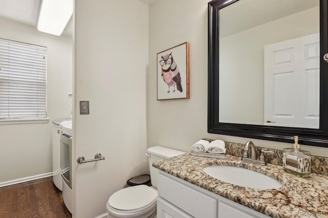 16164 E Hinsdale Ave, Aurora, CO 80016 - bathroom featuring toilet, baseboards, wood finished floors, and vanity