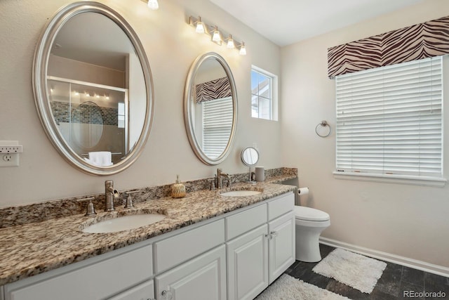 16164 E Hinsdale Ave, Aurora, CO 80016 - bathroom with double vanity, a sink, toilet, and a shower stall