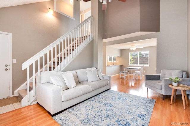 living room with hardwood / wood-style floors and ceiling fan