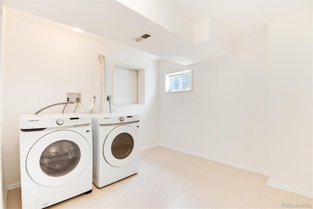 clothes washing area with washer and dryer