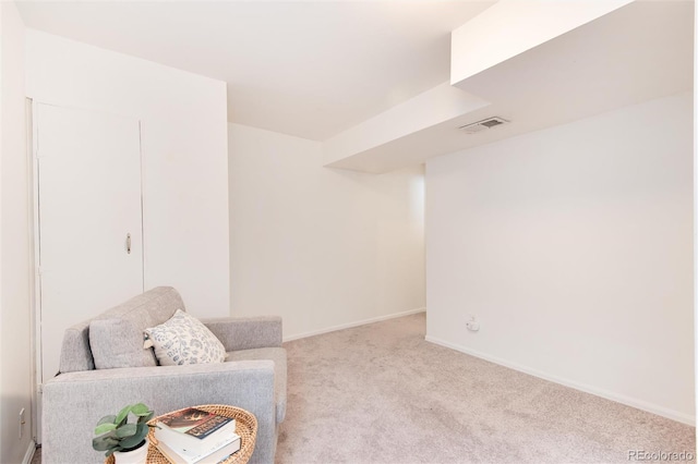 living area featuring light colored carpet