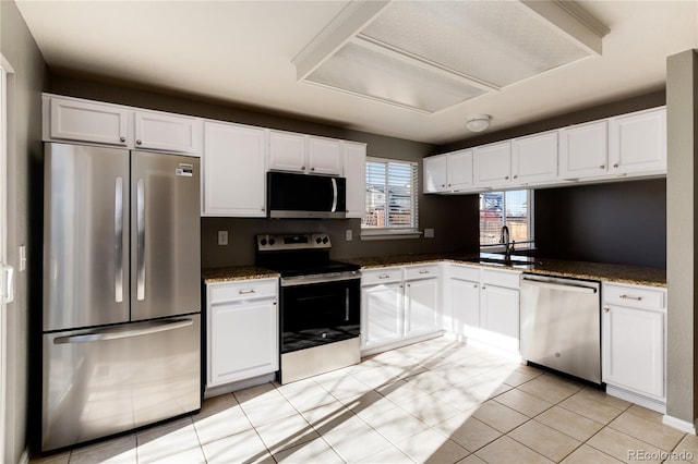 kitchen featuring white cabinetry, light tile patterned floors, and appliances with stainless steel finishes