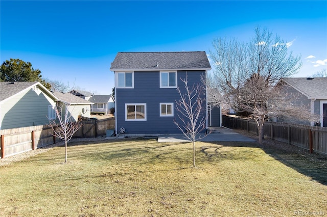 back of property with a lawn and a patio area