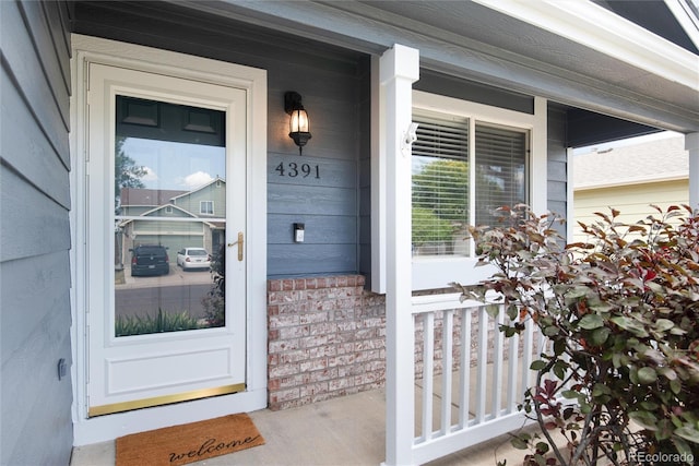 entrance to property featuring covered porch