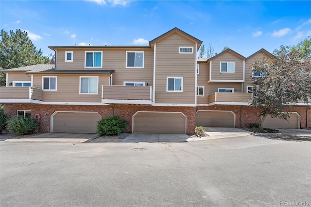 7600 W Coal Mine Ave Unit B, Littleton, CO 80123 - view of front facade with brick siding and a garage