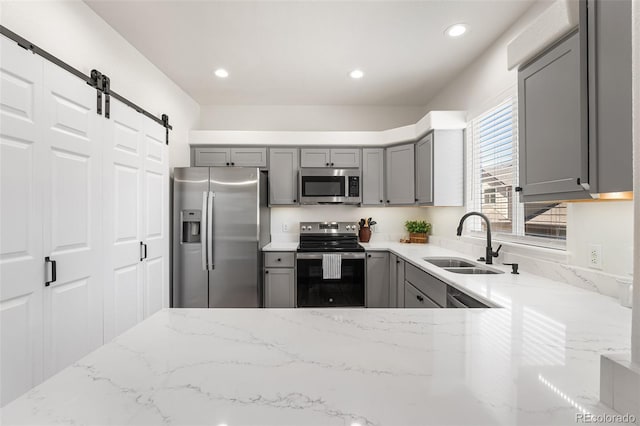7600 W Coal Mine Ave Unit B, Littleton, CO 80123 - kitchen featuring appliances with stainless steel finishes, gray cabinetry, light stone countertops, and recessed lighting