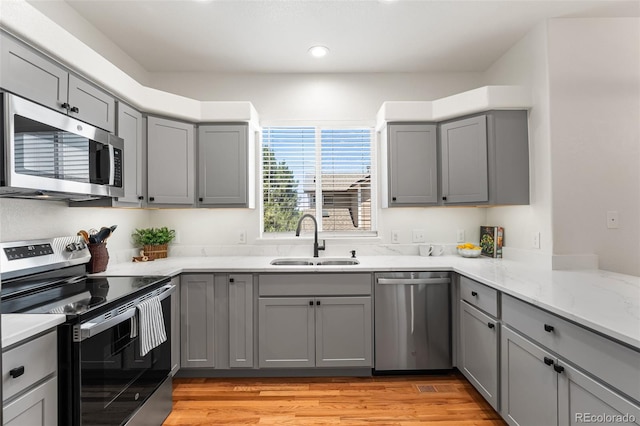 7600 W Coal Mine Ave Unit B, Littleton, CO 80123 - kitchen with stainless steel appliances, gray cabinetry, light wood-style floors, and recessed lighting