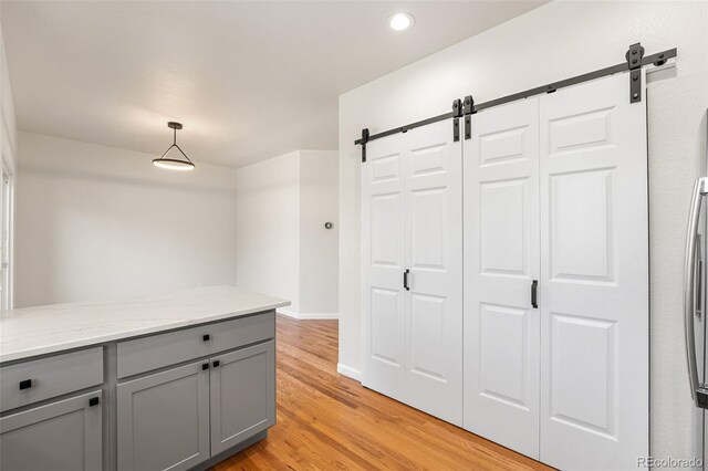7600 W Coal Mine Ave Unit B, Littleton, CO 80123 - hall featuring a barn door, recessed lighting, and light wood-type flooring