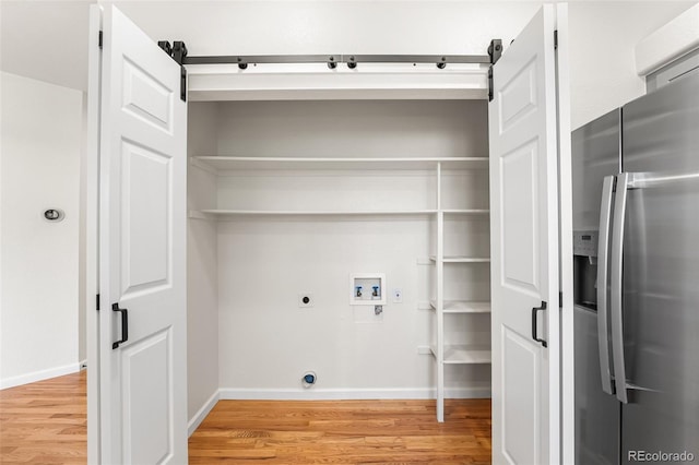 7600 W Coal Mine Ave Unit B, Littleton, CO 80123 - washroom with washer hookup, light wood-type flooring, electric dryer hookup, and gas dryer hookup